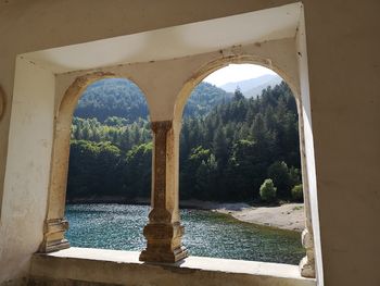 Arch bridge over river in forest