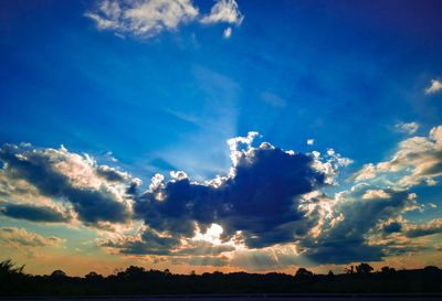 Low angle view of silhouette field against sky at sunset