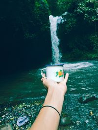 Optical illusion of woman filling water in cup