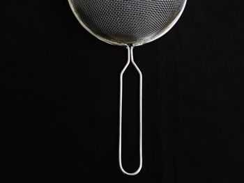 Close-up of drink on table against black background