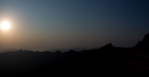 Scenic view of silhouette landscape against sky at night
