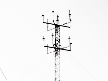 Low angle view of power lines against clear sky