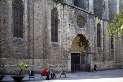 People walking in front of historic building