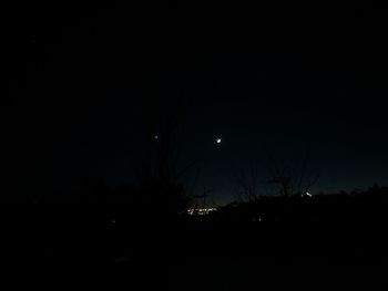 Silhouette landscape against clear sky at night