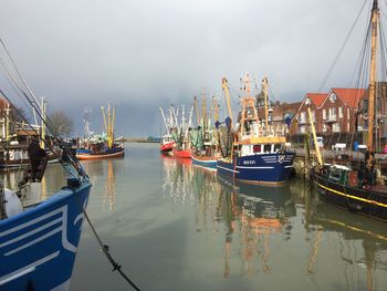 Boats moored at harbor