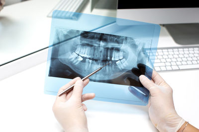 Cropped hands of person working at clinic