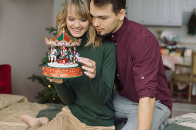 Midsection of couple holding hands