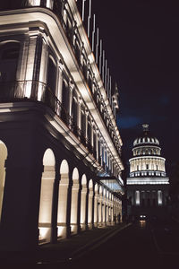 Low angle view of illuminated building against sky at night