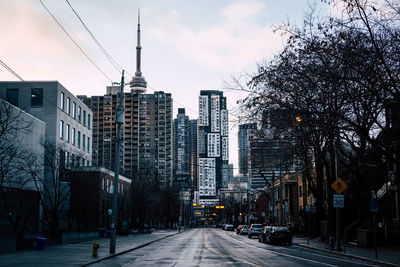 City street and buildings against sky