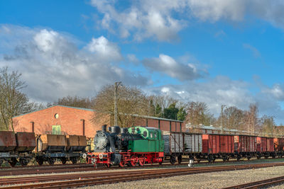 Train on railroad track against sky