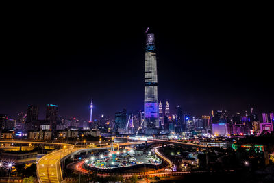 Illuminated modern buildings in city at night