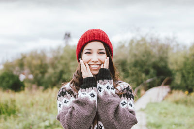 Portrait of smiling young woman in snow