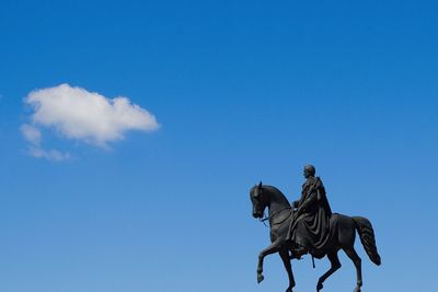 Statue against blue sky