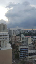 Buildings against cloudy sky