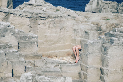 Low section of woman on rock