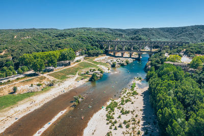 High angle view of river amidst trees against clear sky