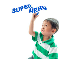 Low angle view of boy standing against white background