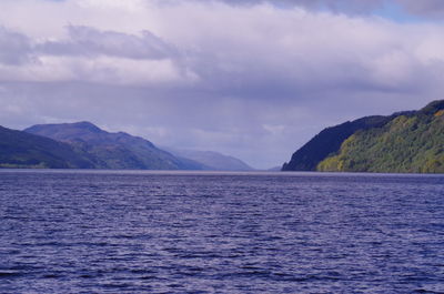 Scenic view of mountains against cloudy sky