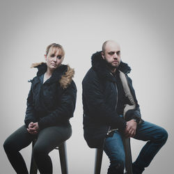 Portrait of young couple against white background