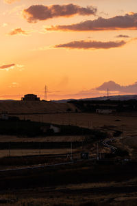 Scenic view of field against sky during sunset