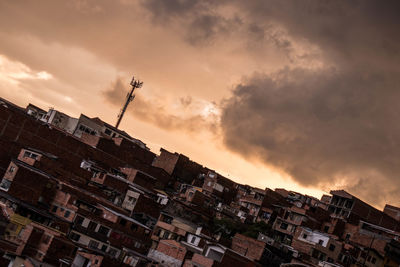 Low angle view of buildings in city at sunset