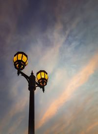 Low angle view of street light against sky at sunset