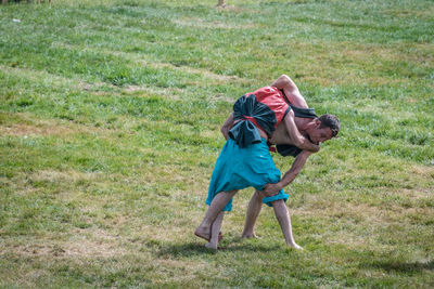 Full length of dog playing on field