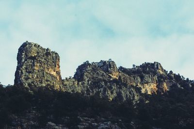 Low angle view of rock formation against sky
