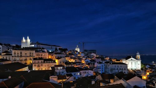 Illuminated city skyline in a shiby night in lisbon, portugal architecture 