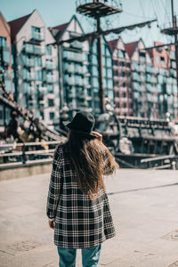 Rear view of woman walking on street