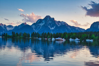 Scenic view of lake by mountains against sky