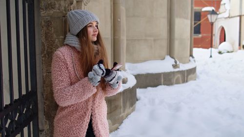 Woman standing in snow