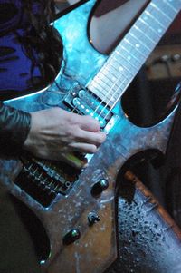 Close-up of man playing guitar