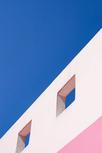 Low angle view of building against clear blue sky