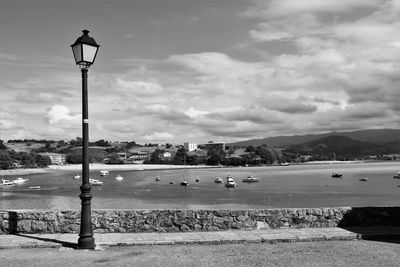 Street light by mountains against sky