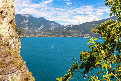 Scenic view of sea and mountains against sky