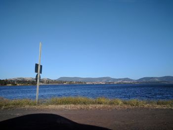 Scenic view of beach against clear blue sky