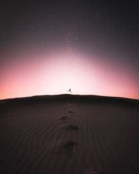 Scenic view of desert against sky at night