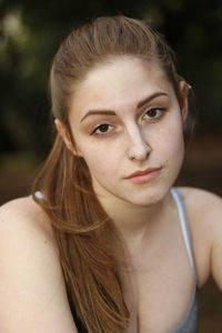 Close-up portrait of sad beautiful woman at park