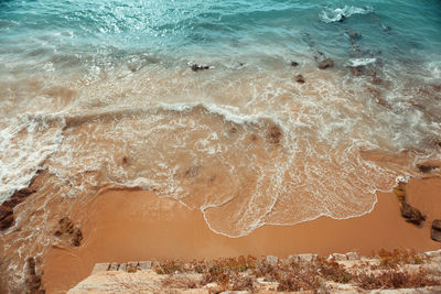 High angle view of sea waves at beach