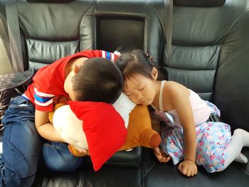 High angle view of people sleeping in bedroom