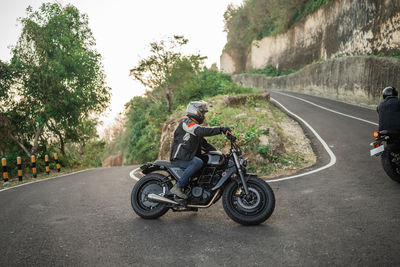 Man riding motorcycle on road