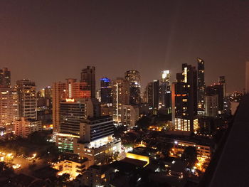 High angle view of illuminated buildings against sky at night