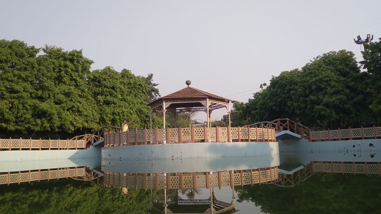 water, architecture, plant, tree, built structure, nature, lake, building exterior, reflection, day, no people, building, outdoors, waterway, sky, aerial photography, travel destinations, vehicle, travel, house