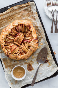 A homemade caramel apple galette on a sheet pan, straight out of the oven.