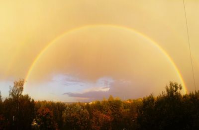 Scenic view of rainbow against sky at sunset