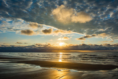 Scenic view of beach against sky during sunset