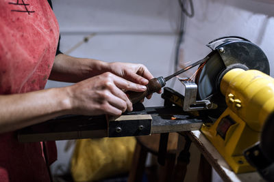 Unrecognized luthier woman in traditional workshop