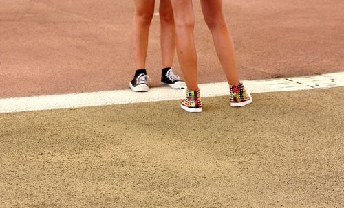 Low section of girls wearing sneakers