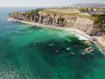 High angle view of rocks on sea shore